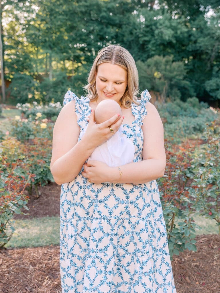Close-up of newborn baby resting in mother's arms at Raleigh Rose Garden.